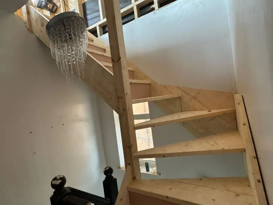 New timber staircase being fitted up into a loft conversion